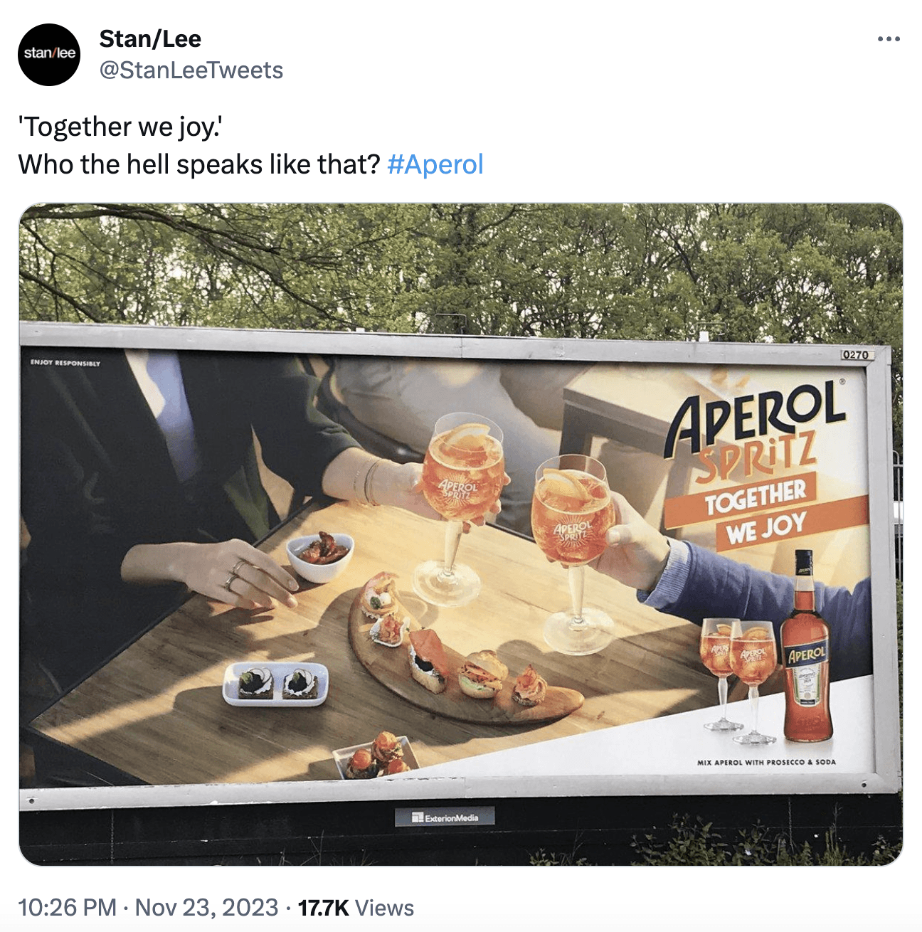 a screenshot from @StanLeeTweets X account, displaying an Aperol Spritz ad with the text 'Together we joy', which represents a bad localisation of the original Italian slogan.